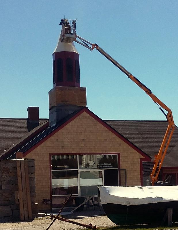 From the ground to the top of the building, a new steeple gets set into place.