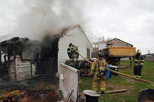 Firefighters work at a Bayside West home in Owls Head Tuesday morning to put out a fire that started in a chicken coop, where a heat lamp was warming four new baby chickens. (Courtesy Rockland Fire Department/by Alan Athearn)