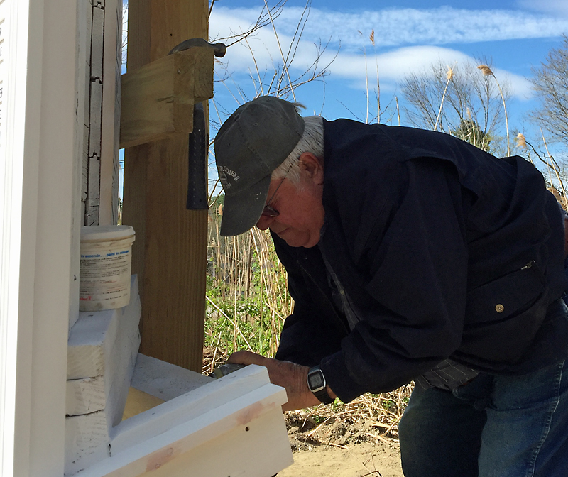 Cecil Dennison does a little more work securing the Honor Roll to its base. (Photo by Holly S. Edwards)