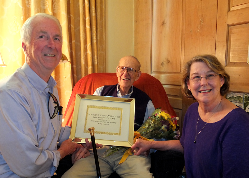 Peter Blyberg and Carol hold the plaque presented to Maurice Granville.