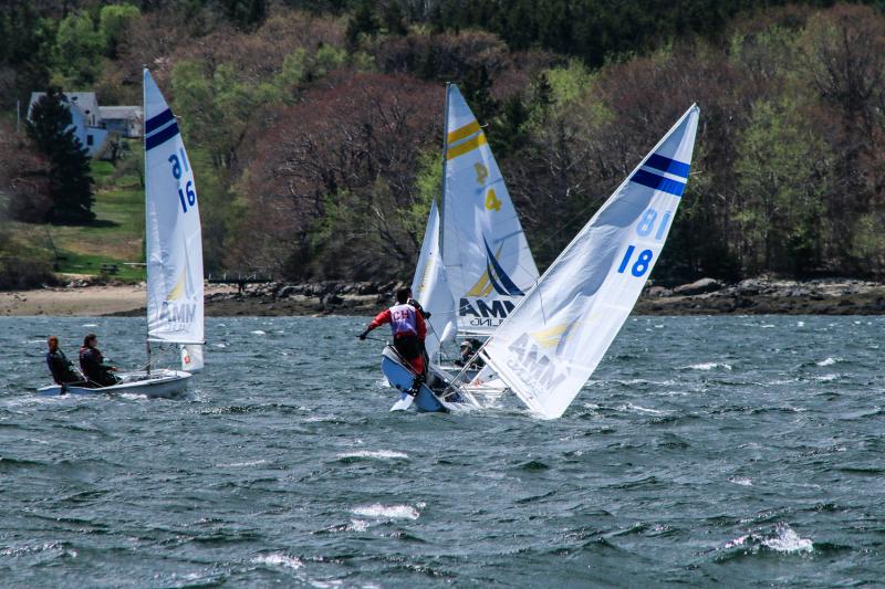 Blustery conditions on Sunday made for some exciting and wet racing. Acosta and Lyman team from CHRHS (number 18) tack into the fleet. (Photo Courtesy of David Lyman)
