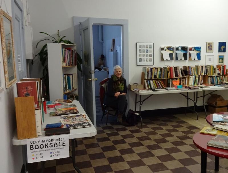 Volunteer Deborah Stevenson at the Waterfall Arts book sale. (photo by Erica Thoms)