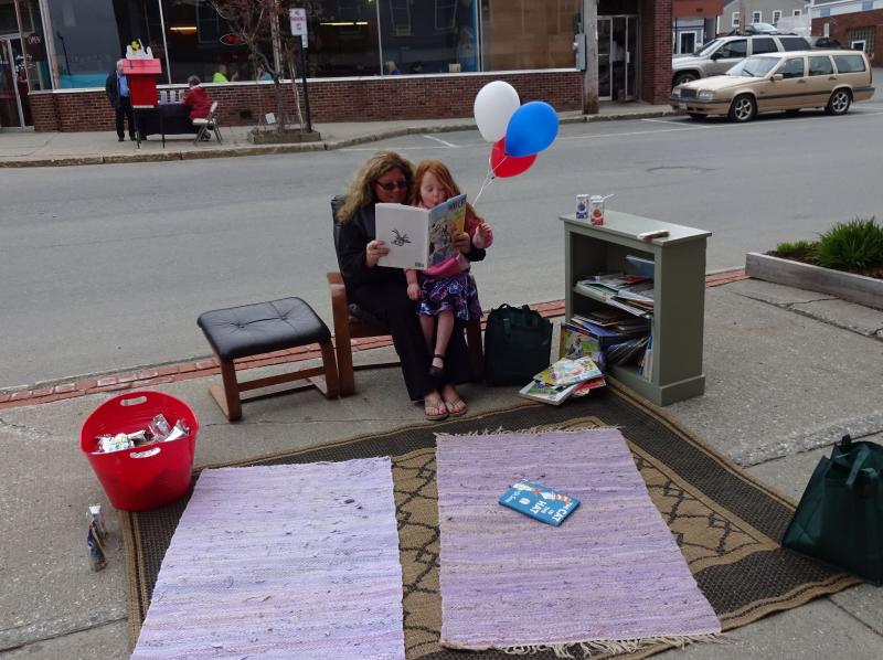 Michelle Ridley and daughter and Sophia take advantage of the Reading Corner. (photo by Erica Thoms)
