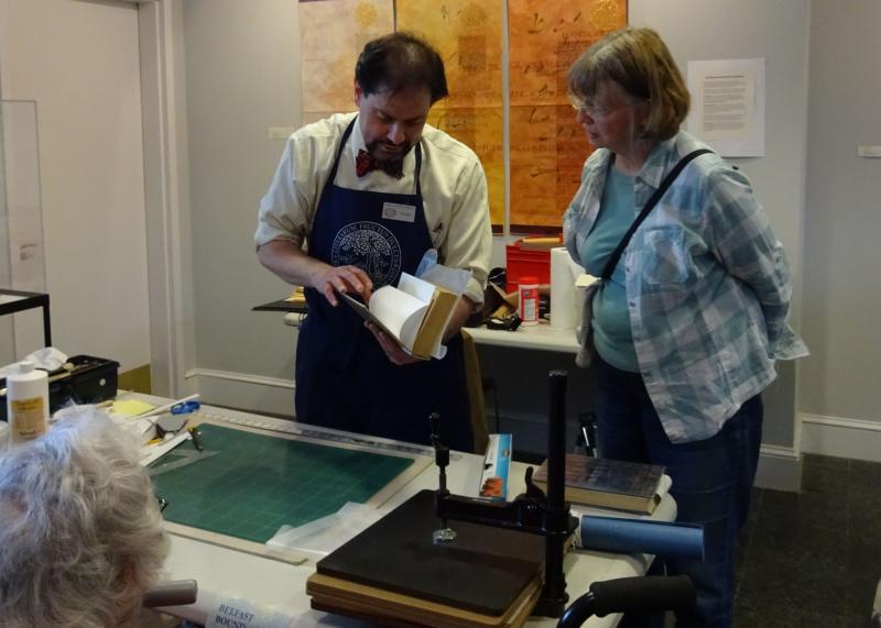Portland Public Library Archivist Abraham Schecter gives a demonstration on book conservation at the Belfast Free Library. (photo by Erica Thoms)