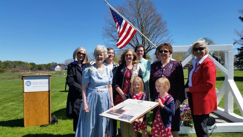 Suzy Shaub (in blue dress) stands with members of the Lady Knox Chapter, DAR, near the new sign for the Revere bell on the grounds of the Knox Museum. The sign is dedicated in Shaub’s honor. (Photo by Sarah Shepherd)