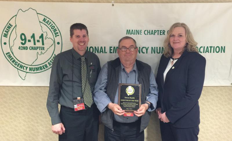Outgoing NENA President Tammy Barker (left) and incoming president Brodie Hinkley (right) present Waldo County Communications Director Owen Smith with a plaque and certificate. (Photo by Mike Larrivee)