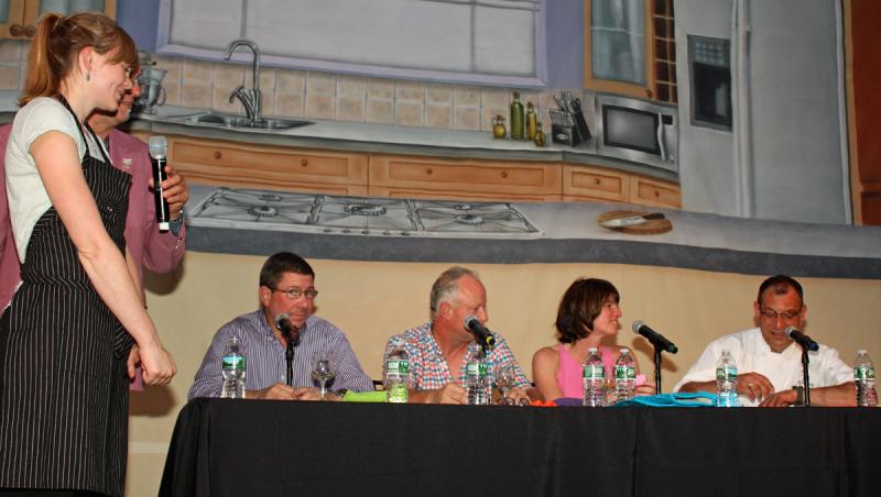 Eventual winner Shelby Stevens, of Natalie's at Camden Harbour Inn, describes her Blackberry Tarragon Parfait to judges Michael Salmon of Hartstone Inn and Hideaway, Lani Stiles of Megunticook Market, Phillip Crispo of Norumbega Inn and Norm Herbert of Bintliff's Ogunquit Restaurant. (Photo by Holly S. Edwards)