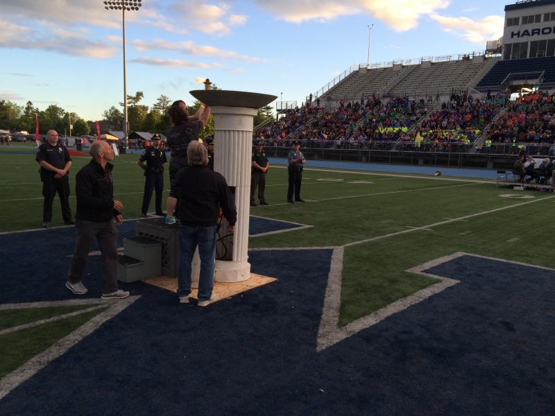The lighting of the torch at the opening ceremony. (Photo by Justin Hills)