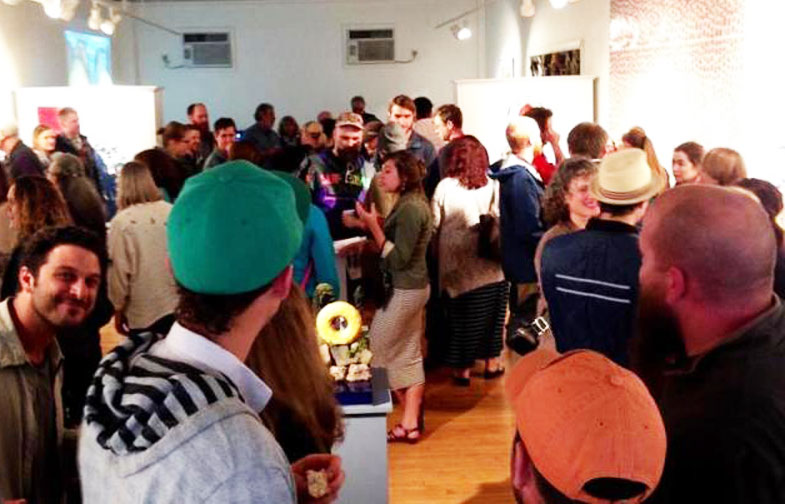 The opening night crowd to the “Hole History: Origins of American-Style Donut” show at Asymmetrick Arts in Rockland on June 3 (National Donut Day) which runs to June 25. (Photo courtesy Alexis Iammarino)