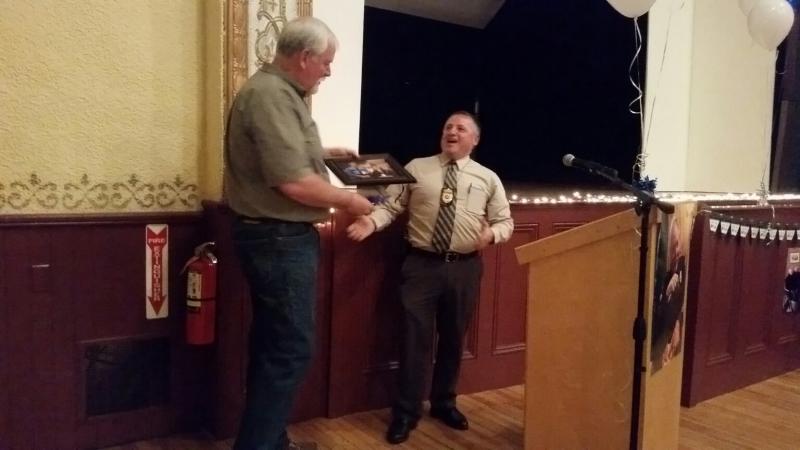 Camden Police Chief Randy Gange presents Kelley a framed photo taken during one of their corresponding shifts in 1989. (Photo by Sarah Shepherd)