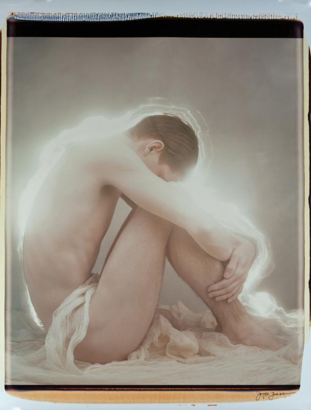 Man with head in knees. (Photo courtesy Joyce Tenneson)