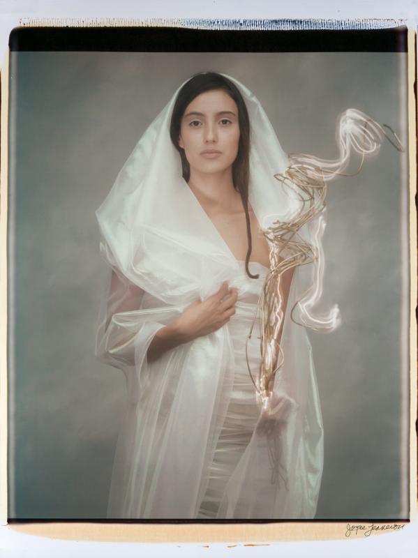 Woman with lit branch. (Photo courtesy Joyce Tenneson)