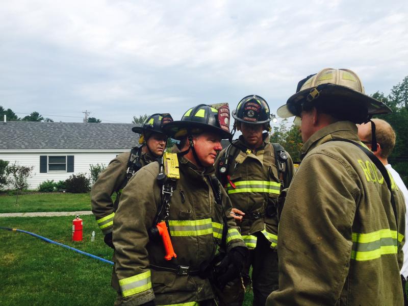 Rockport firefighters Bill Lane and Justin Ford talk with Asst. Fire Chief John Wickenden about inspection of the fire scene. (Photo by Lynda Clancy)