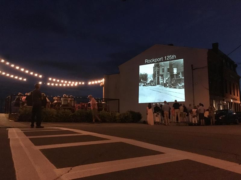 Following the bridge dinner, many people wandered up to Union Hall, where historical photos of Rockport were being projected on the wall for the final night of the week. (Courtesy Joe Ryan)