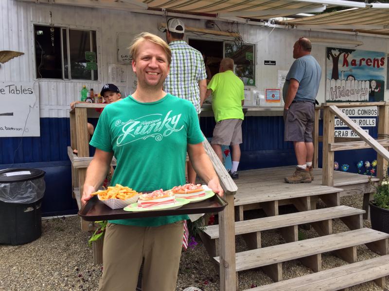 A happy customer with lobster rolls at Karen’s Hideaway on Route 27 in Boothbay. SUZI THAYER/Boothbay Register