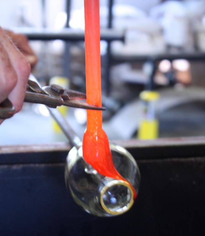 Directing the pipe while adding the colored lip wrap. (Photo by Holly S. Edwards)