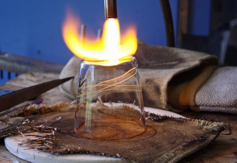 Smoothing the bottom of the finished glass with a torch. (Photo by Holly S. Edwards)