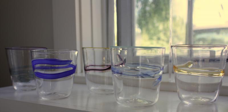 Another set of the finished drinking glasses. The newly created glasses must spend a day in the annealing kiln, where a computer maintains a consistent 960 degree temperature, allowing the molecules to settle and all the stress to come out of the glass before slowly bringing the pieces to room temperature. (Photo by Holly S. Edwards)