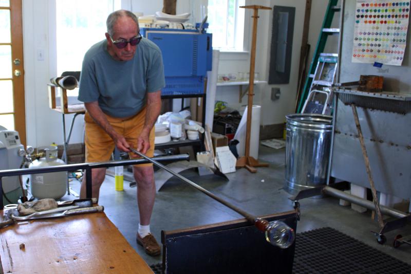 Because the glass is hot, it needs to be constantly rotated so it does not bend or flop over on itself. (Photo by Holly S. Edwards)
