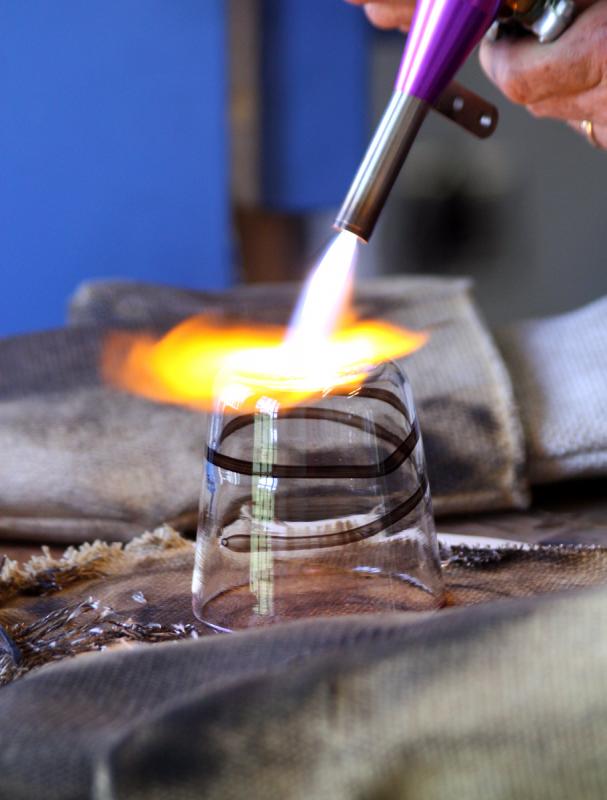 A few seconds under this torch smooths the bottom of the glass and then it’s ready for the annealing oven to slowly cure and cool overnight. (Photo by Holly S. Edwards)