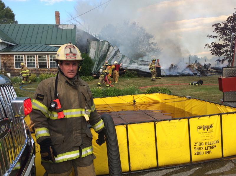 Lincolnville was one of the handful of mutual aid towns called to assist Belmont Fire Department in battling the late Saturday afternoon fire at 24 Lincolnville Road. Pictured is Lincolnville Fire Chief Ben Hazen. (Photo by Holly S. Edwards)