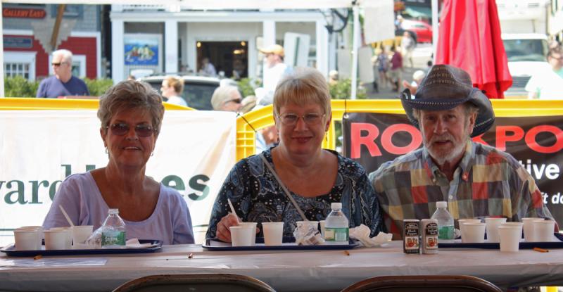 Julia Libby, left, of Lincolnville, is joined by two friends during the West Bay Rotary Chowder Challenge. (Photo by Holly S. Edwards)