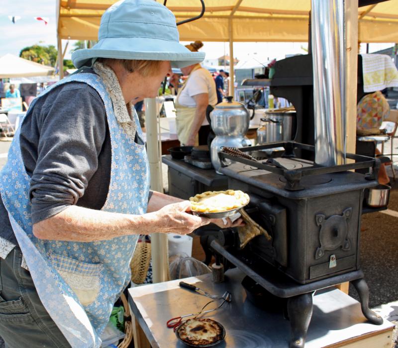Lynette Walther of Camden bakes miniature apple pies in her new, antique mini-wood stove. (Photo by Holly S. Edwards)