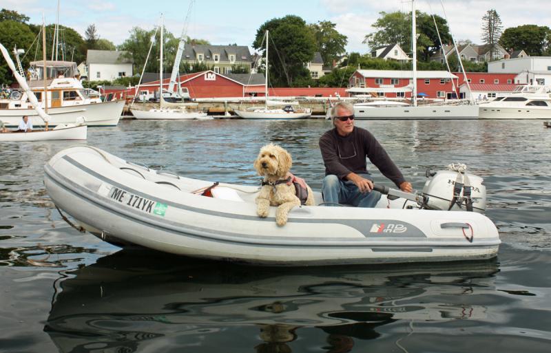 Capt. Rick Bates and one of his two Labradoodles, a fine boat dog if ever there was one. (Photo by Holly S. Edwards)