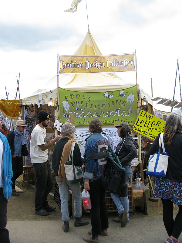 A gathering at the Beehive Design Collective booth.