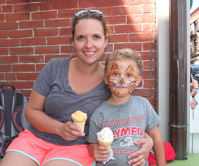 Sarah Lewler from Belfast with her ice cream cone, and her son, Zephyr, with his freshly painted tiger face and a cone with rainbow sprinkles.