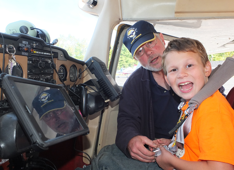Ken Otmann, pilot, and JJ prepare for a flying lesson.