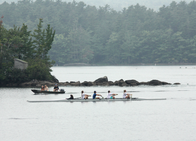 A Megunticook Rowers team passes by exposed rocks in Megunticook Lake on Sept. 19. The lake is about 2 feet lower than it normally is this time of year, due to a lack of rain and leaks at Seabright Dam, which helps control and maintain the river level as it passes through town and empties into the head of Camden Harbor.. (Photo by Holly S. Edwards)