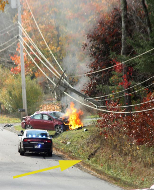 The yellow arrow shows where the car went off the road into the ditch and then up an embankment, which went it airborne into the utility pole, shattering it and leaving it hanging overhead. (Photo by Holly S. Edwards)