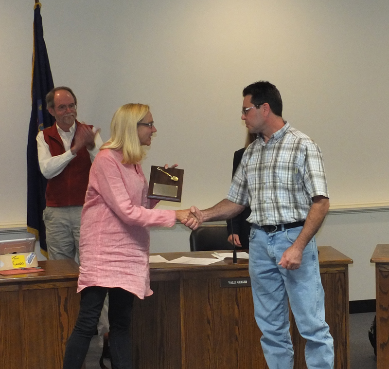 Assistant Public Services Director Christopher Donlin receives a handshake and a plaque from Mayor Louise MacLellen-Ruf for a job well done.