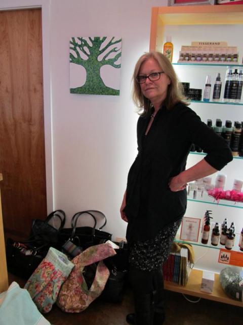 RHEAL Day Spa Rhonda Nordstrom with bags collected in the first year of the project. (Photo by Kay Stephens)