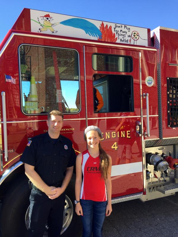 The seventh-grade winner is Rachel Rademacher, a student at CRMS, with firefighter Taylor Benzie. (Photo courtesy of Jaime Stone)
