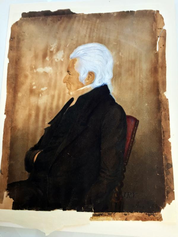 A portrait of a Captain Grovner, done in 1830, was painted on paper that had been wrapped around a wood panel, then framed. The brownish color and grain of the wood had seeped into the paper.