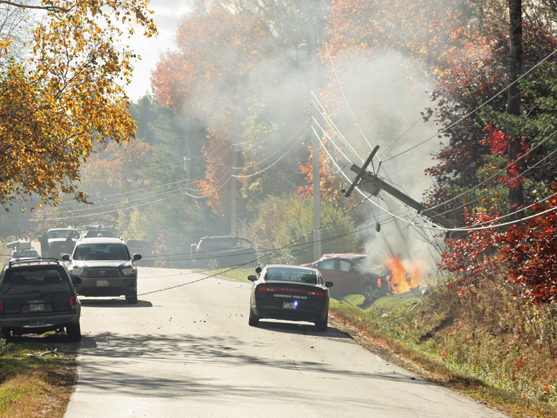 Early at the scene of the accident, before firefighters had arrived to put out the growing car fire blaze. (Photo by Holly S. Edwards)