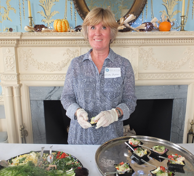 Linda Butler serves up smoked salmon prepared by the museum.