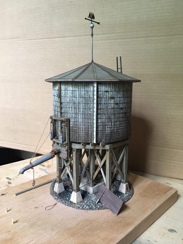 The O-scale water tower under construction with a Lee Turner plow on the right. Turnerize: to transform average O-scale model railroad products into steam era masterpieces.