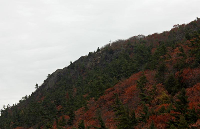 Maiden’s Cliff and the memorial cross overlook Megunticook Lake in Camden, at the Lincolnville town line. (Photo by Holly S. Edwards)