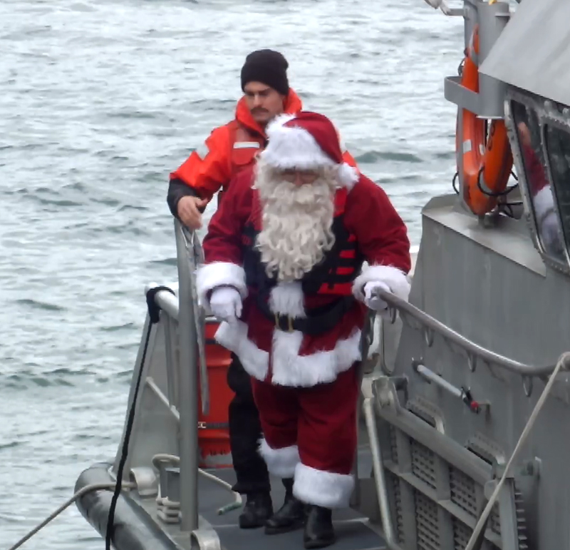 Santa arrives with the help of the U.s. Coast Guard. (Photos by Chris Wolf)