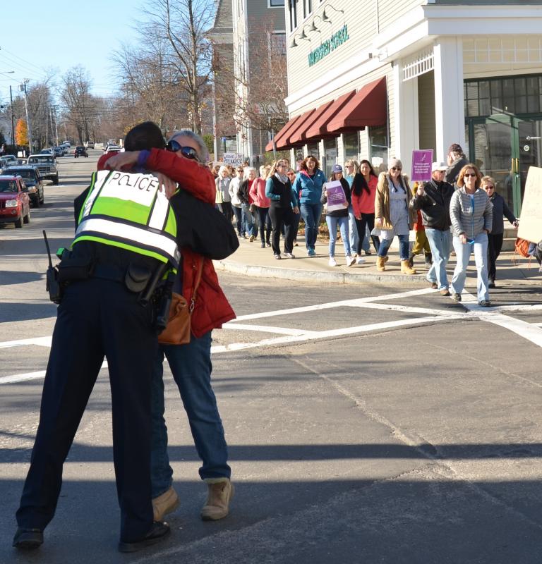 Camden Police Sgt. Allen Weaver Jr. gets a hug from a ctizen. (Photo by Lynda Clancy)