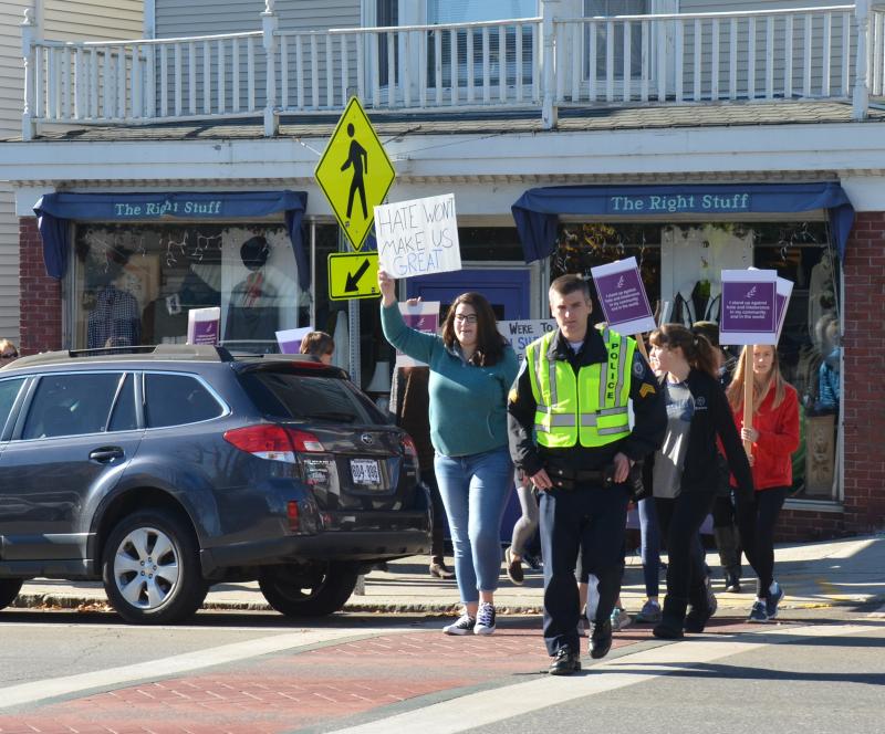 Camden Police Officer John Tooley leads the march across Route 1. (Photo by Lynda Clancy)