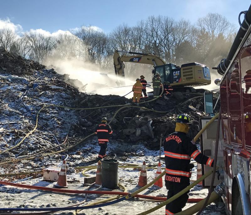 Rockport firefighters are back at the landfill at Mid-Coast Solid Waste along with a Sargent excavator, working to put out the reignited fire from Monday. (Photo by Holly S. Edwards)