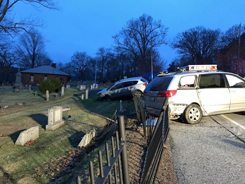 Two vehicles ended up going through the iron fence along Mountain View Cemetery late Wednesday afternoon, after one of the drivers told police he had a medical problem, causing him to cross the centerline and collide with not only one but two oncoming vehicles, the other being a Penobscot Bay YMCA school bus. (Photo by Holly S. Edwards)