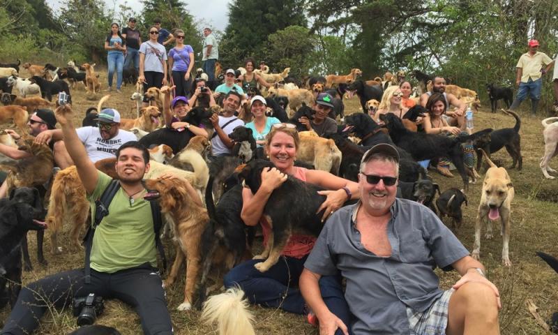 Caroline Canning, center, holding a pup, with her husband Jay, right, at Territorio de Zaguates. Courtesy of Caroline Canning