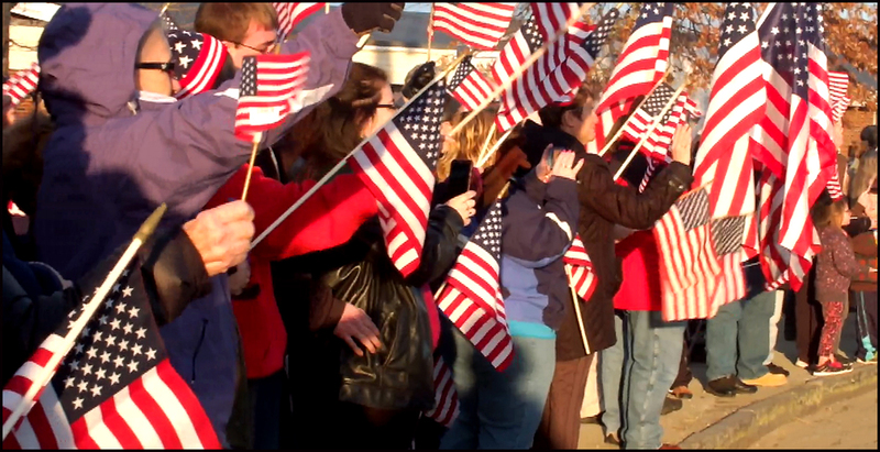 A flag waving crowd greets the Wreaths Across America convoy as they enter Medomak Valley High School. (Photos by Chris Wolf)