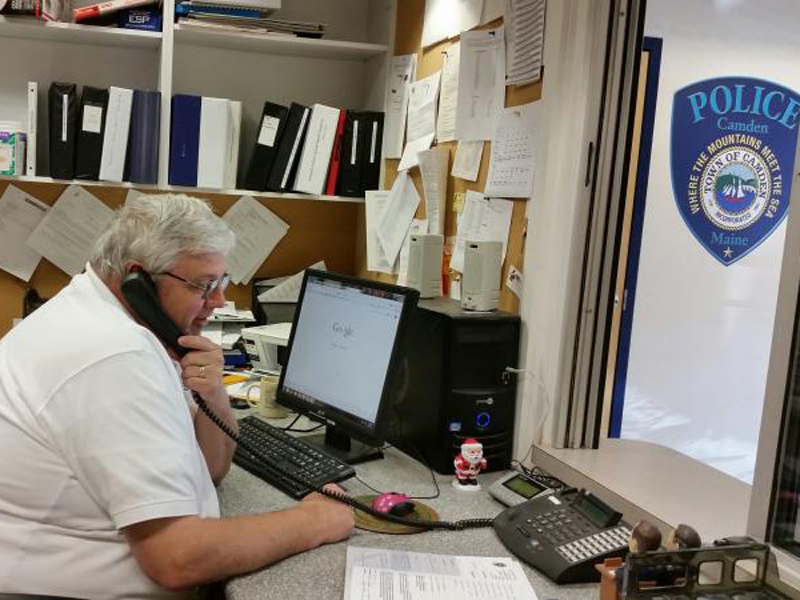 Jeff Sukeforth, program coordinator for Good Morning Camden, is busy on the phone making his daily outreach calls to the seniors registered in the program. (Photo by Sarah Shepherd)