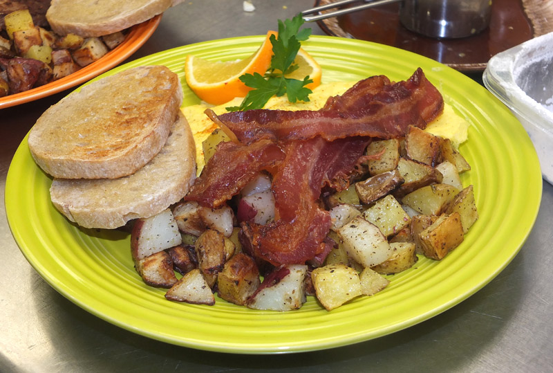 Eggs, bacon and hash browns with oatmeal toast
